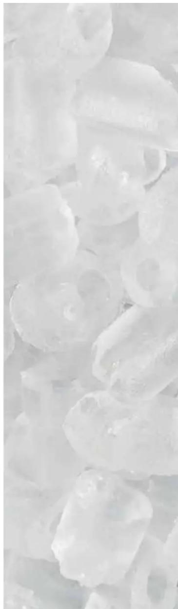 Close-up of translucent, irregularly shaped white crystalline particles with no visible text or symbols