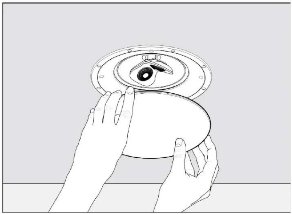 Line drawing of hands holding a circular object with a lid and central eye (no text or symbols)