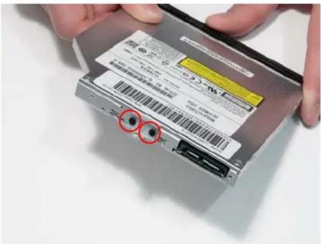 Close-up of hands holding a computer drive with a visible label and barcode, with two red circles highlighting features.