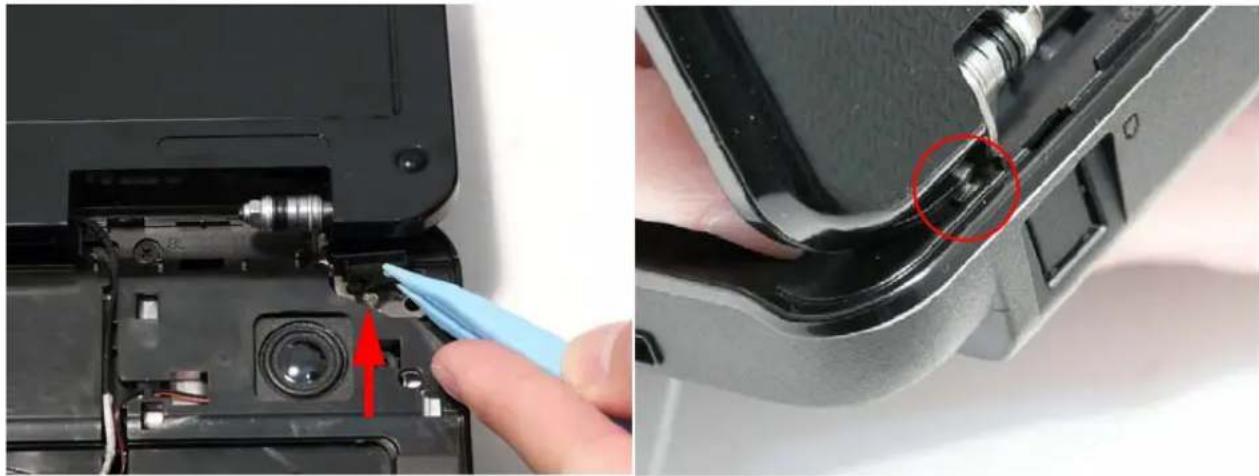 Close-up of a hand using a tool to adjust or install electronic components on a device (no visible text or symbols)