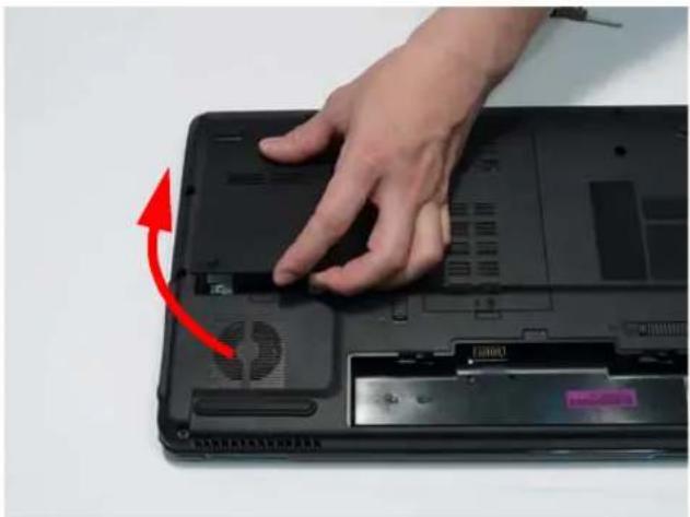 Hand pressing down on a laptop keyboard with a red arrow indicating the press direction.