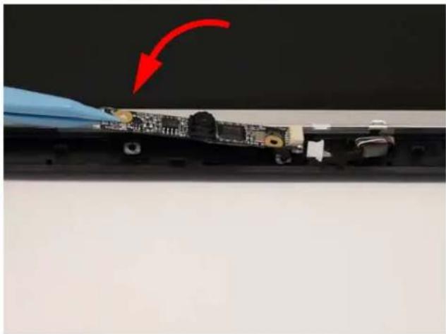 Close-up of a damaged electronic component with a red arrow indicating a downward motion (no text or symbols visible).