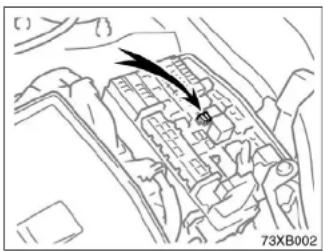 Technical diagram of an engine compartment with a black arrow pointing to a component (no text or symbols present)