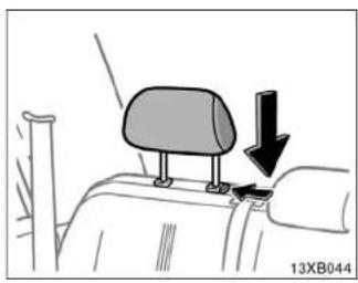 Diagram of a car seatbelt with a downward arrow indicating force or movement (no text or symbols present)