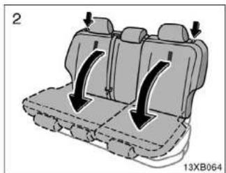 Diagram of a vehicle backseat with directional arrows indicating movement or force (no text or symbols present)