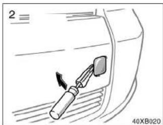 Diagram of a car interior showing a tool inserted into a component, with no visible text or symbols.
