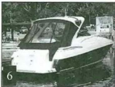 Exterior view of a white and black boat parked on water with trees in the background (no visible text or symbols)