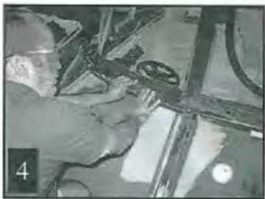 Close-up of hands using a tool on a mechanical component, no visible text or symbols