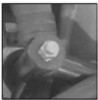 Close-up of a hand holding a small object, possibly a tool or device, with no visible text or symbols.