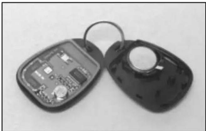Two black key-shaped objects with visible internal circuit boards, one open and one closed (no text or symbols)