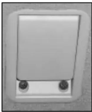 Close-up of a white rectangular electronic component with two small circular holes, no visible text or symbols.