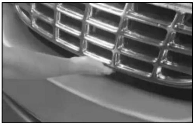 Close-up of a car grille and dashboard (no visible text or symbols)