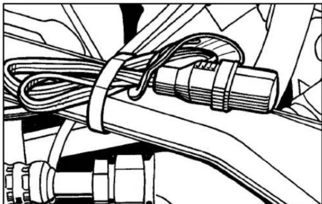 Technical line drawing of a mechanical assembly with coiled cable and connectors (no text or symbols)