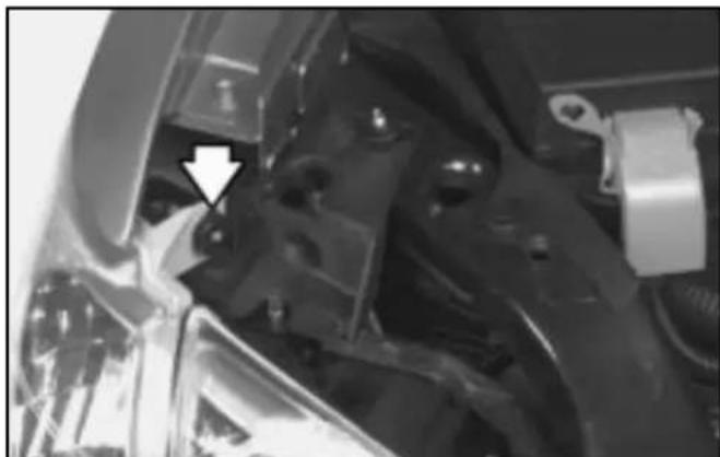 Close-up of mechanical components with a white arrow pointing to a specific part (no visible text or symbols)