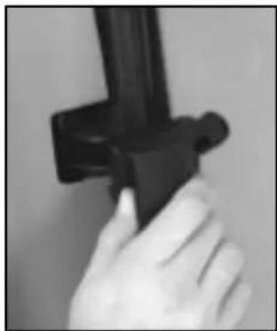 Close-up of a hand holding a black mechanical component (no visible text or symbols)