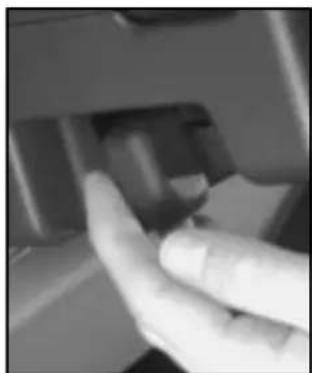 Close-up of a hand pressing a button on a mechanical component (no visible text or symbols)