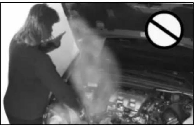 Black-and-white photo of a person using a smartphone in a dimly lit room with a large 'no' symbol overlay (no readable text or symbols)
