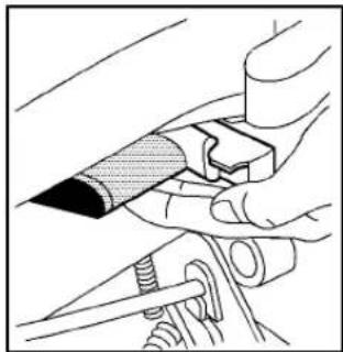 Illustration of hands using a tool to adjust or install a mechanical component (no text or symbols visible)