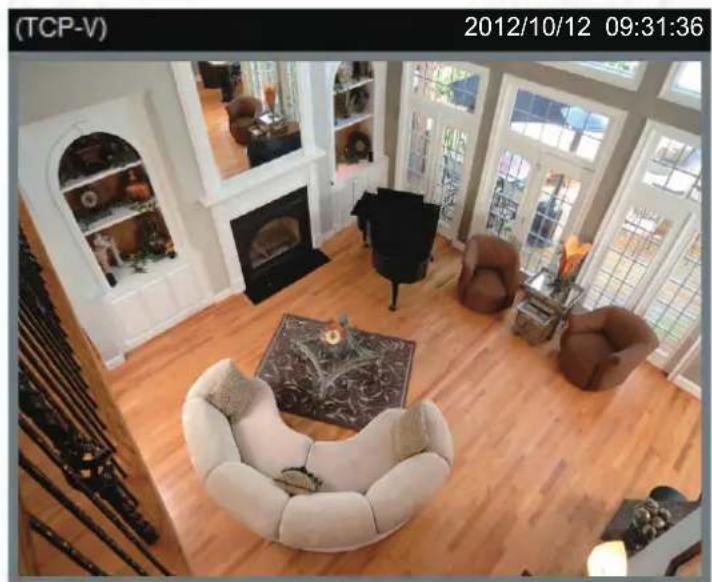 Interior view of a modern living room with wooden flooring, featuring white furniture and large windows (no visible text or symbols)