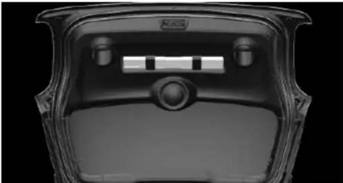 Top-down view of a transparent plastic car trunk with internal compartments and a central knob (no visible text or symbols)