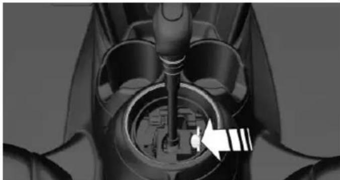 Close-up of a mechanical component with a white arrow pointing to a circular feature (no visible text or symbols)
