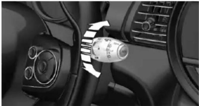 Interior view of a car dashboard with steering wheel and directional arrow (no text or symbols)