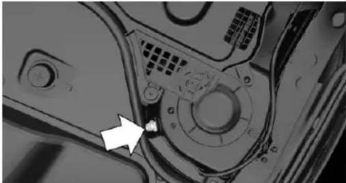 Close-up of a mechanical component with a white arrow pointing to a small feature, no visible text or symbols.