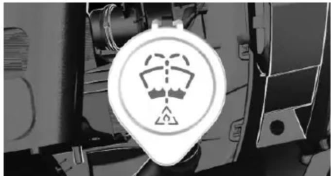Black and white photo of a vehicle's front view with a circular warning sign (no readable text or symbols)