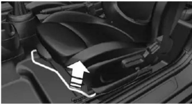 Interior view of a car seatbelt seat with a white arrow indicating the seatbelt (no text or symbols visible)