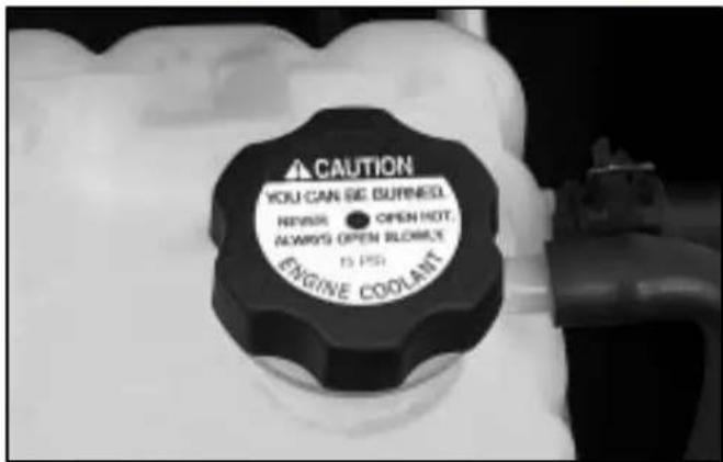 CAUTION YOU CAN BE BURNED. NEVER • OPEN HOT. ALWAYS OPEN BLOWE (5 PS) ENGINE COOLANT