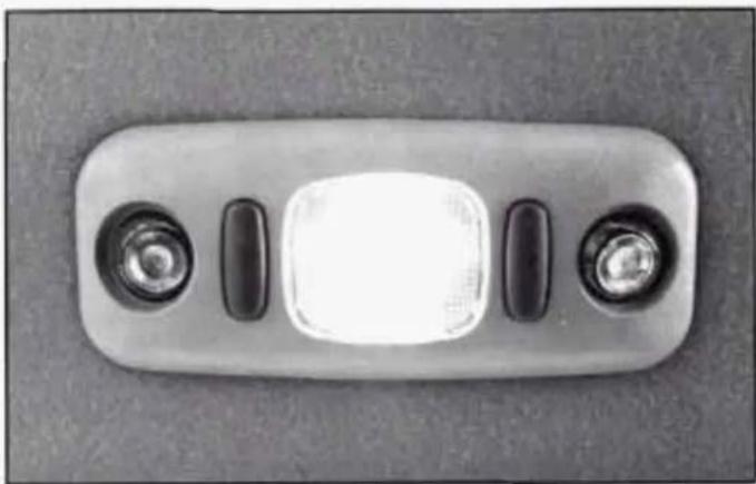 Close-up of a metallic rectangular electronic device with two glossy buttons and a central illuminated square (no text or symbols visible)