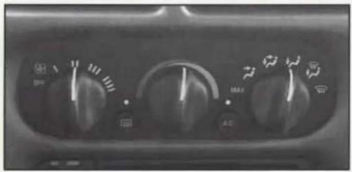 Close-up of a car air conditioning dashboard with dials, switches, and buttons (no readable text or symbols)