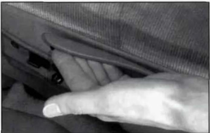 Close-up of a finger pressing down on a car's side panel (no visible text or symbols)
