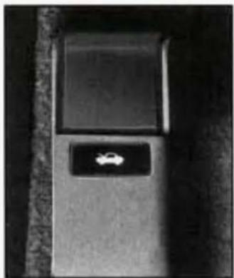 Close-up of a small car slot with a white car icon on the side panel, against a dark background (no text or symbols visible)