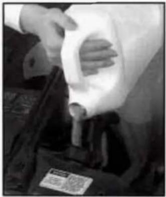 Person handling a white plastic container with a label, no visible text or symbols