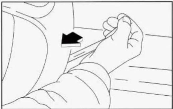 Line drawing of a person's arm and hand holding a small object, with no visible text or symbols
