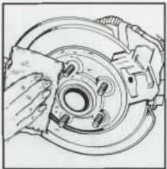 Line drawing of a hand adjusting a car brake caliper on a wheel (no text or symbols)
