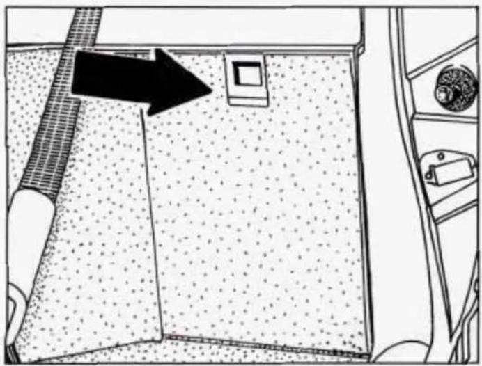 Interior view of a kitchen area showing a tiled floor, a small square object, and a door handle (no text or symbols)