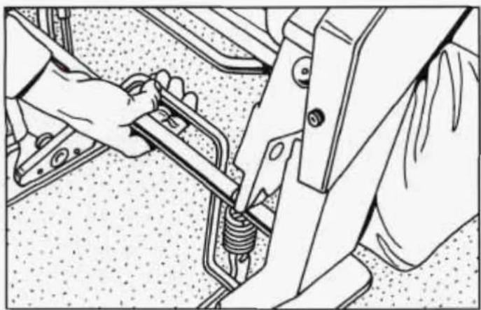 Technical line drawing of a mechanical assembly with hands operating a spring-loaded component (no text or symbols)