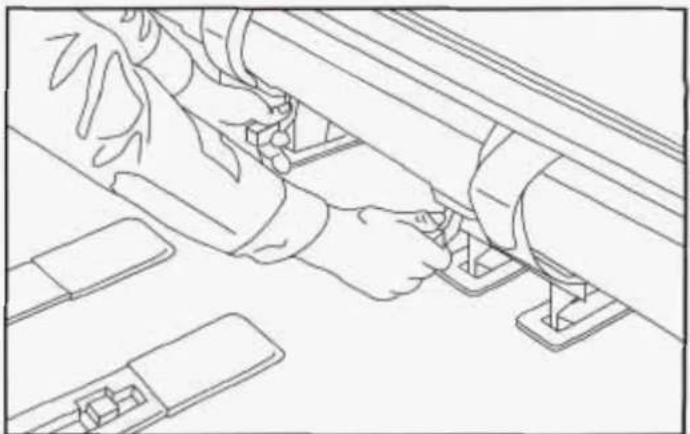 Line drawing of a person using a tool on a mechanical component (no text or symbols)