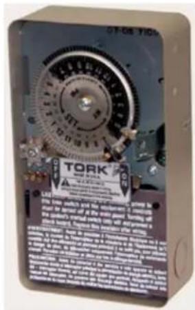 Scanned image of an electronic device labeled 'TORK' with technical specifications and a circular dial indicator.