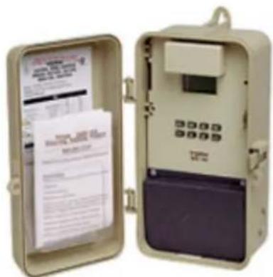 Photo of an open electrical meter device with printed documents and a keypad, showing visible text and labels.