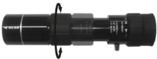 Close-up of a black cylindrical mechanical component with rotational arrows indicating motion (no visible text or symbols)