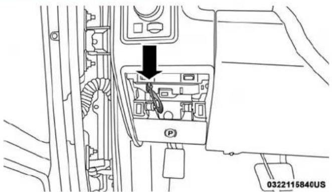Technical diagram showing a car interior with a parking unit and directional arrow indicating movement or force.