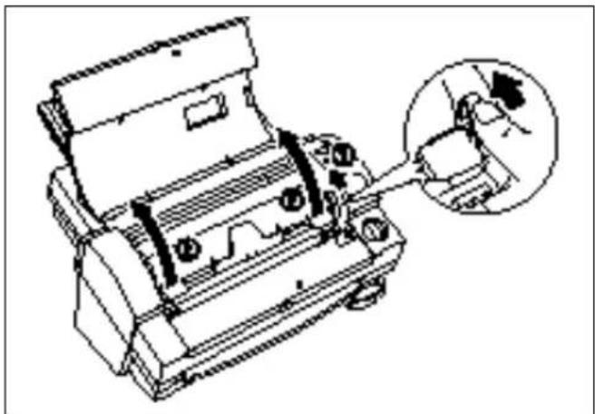 Technical line drawing of a mechanical device with a magnified inset showing a hand interacting with a component (no text or symbols present)