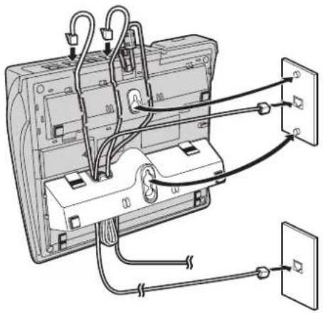 Diagram showing cable connections between a computer monitor and two wall-mounted electrical outlets with labeled components.