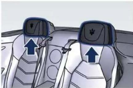 Interior view of a car showing two seats with seatbelt covers and directional arrows indicating movement (no text or symbols)