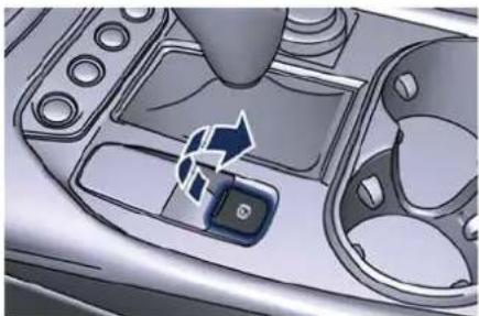 Close-up of a car dashboard with a control panel and directional arrow (no text or symbols visible)