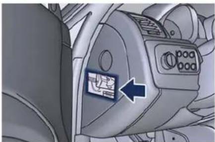 Close-up of a car dashboard with a blue arrow pointing to the left side of the door (no visible text or symbols)