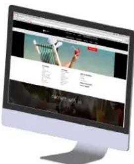 Computer monitor displaying a website with navigation menu and promotional text blocks